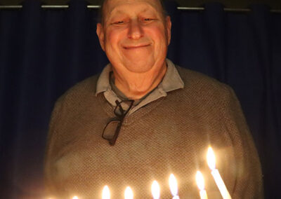 Man Happy With Chanukah Candles Saratoga Congregation Shaara Tfille