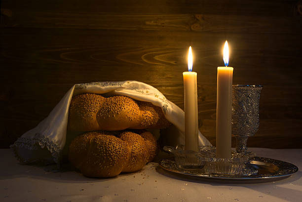 Lit Shabbat candles, chalah and a kiddish cup
