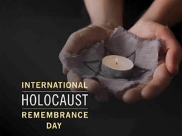 International Holocaust Remembrance Day with hands holding a candle