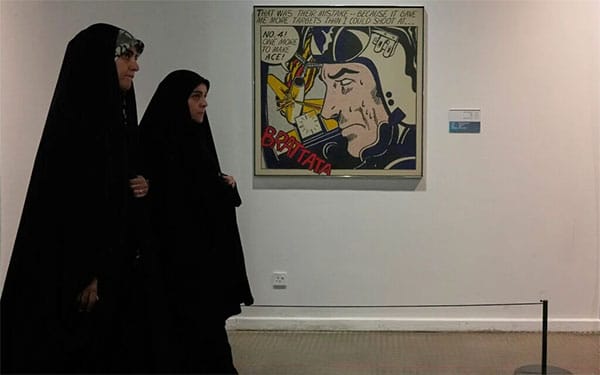 Iranian women walk past American Jewish artist Roy Lichtensteins Brattata